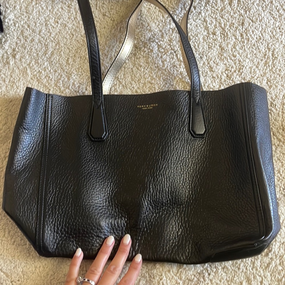 Tory Burch reversible black and gold bag. It’s never been used!